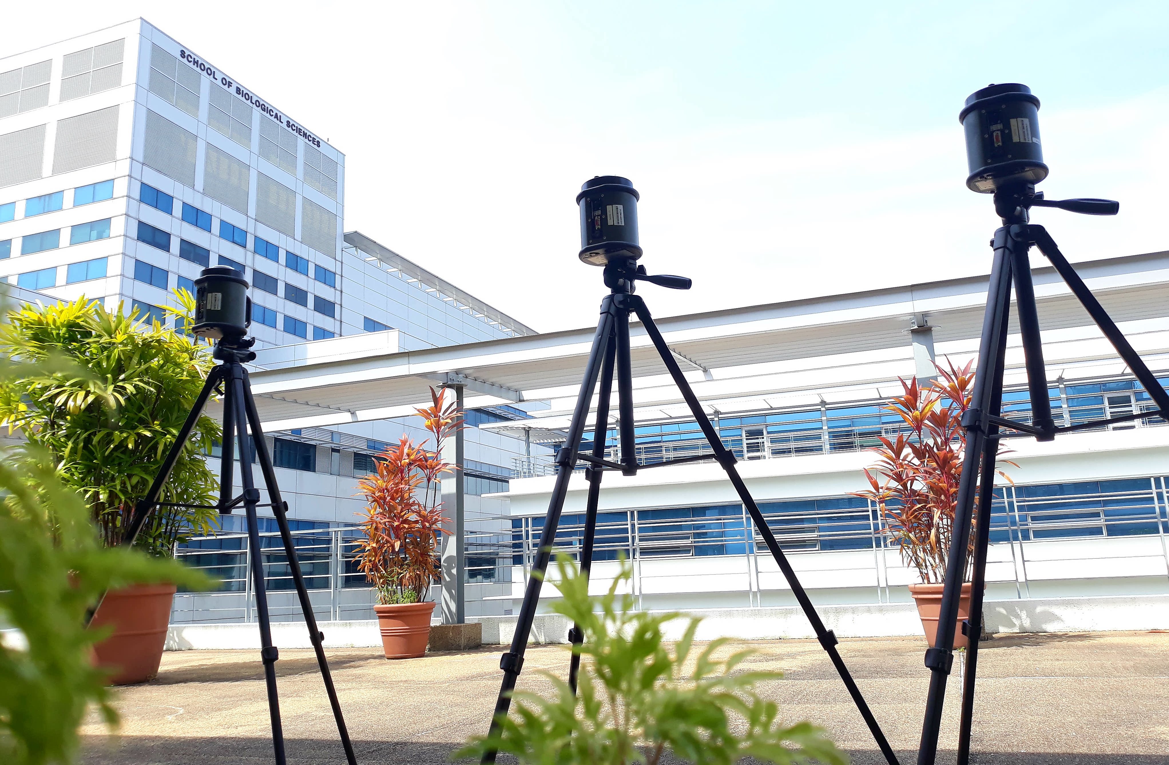Three SASS high volume air samplers on tripods set-up on a balcony located at Nanyang Technological University a clear day